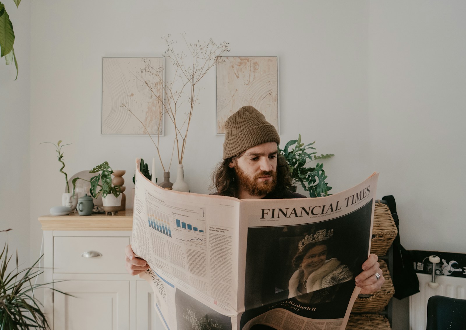 A reader studying a financial newspaper